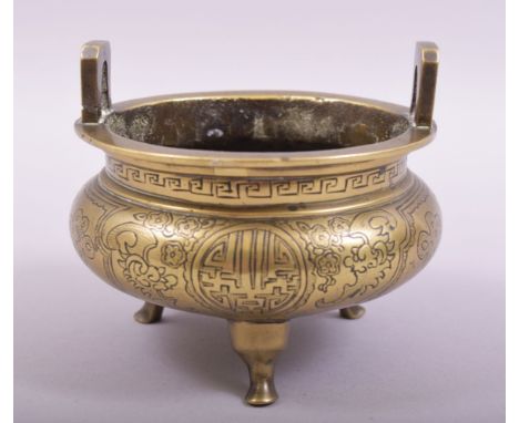 A CHINESE BRONZE TWIN HANDLE TRIPOD CENSER, with engraved and chased decoration, the base with six-character mark, 11.5cm dia