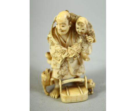 A JAPANESE CARVED IVORY NETSUKE, of a father and son, the father holding a turtle with dogs at his feet, 6cm high.