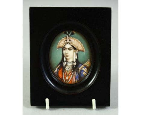 AN INDIAN MINIATURE OVAL PORTRAIT OF A FEMALE FIGURE on ivory, in an ebonised wood frame and glazed, image 6cm x 5cm.