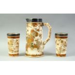 A PAIR OF SATSUMA PORCELAIN BEAKERS AND JUG, all with silver band rims, (one af).
