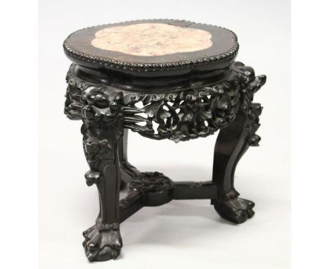 A SMALL CHINESE HARDWOOD AND MARBLE INSET STAND, with shaped top, carved and pierced frieze on three carved legs united by st