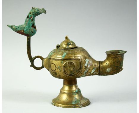 AN ISLAMIC GILT BRONZE OIL LAMP, with lid and zoomorphic finial, 20cm long.