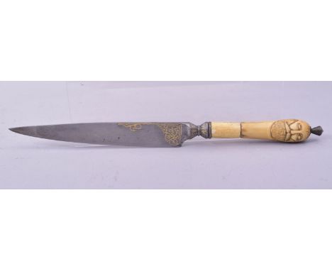 AN UNUSUAL OTTOMAN OR PERSIAN DAGGER with carved walrus handle in the form of a male face to either side and with gold inlaid