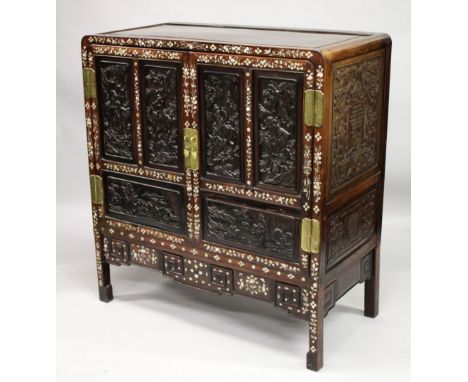 A CHINESE MOTHER OF PEARL INLAID HARDWOOD CABINET, with two large doors opening to reveal a central shelf with two drawers, e