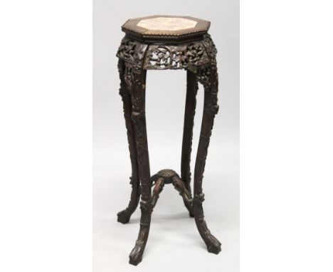 A CHINESE ROSEWOOD AND MARBLE INSET OCTAGONAL SHAPED VASE STAND, with bead carved top, pierced and carved frieze with similar