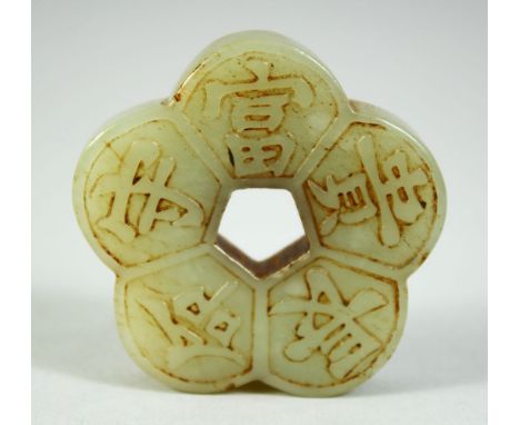 A CHINESE CELADON JADE PENDANT, of lobed pentafoil form, decorated with auspicious characters, 2in wide.