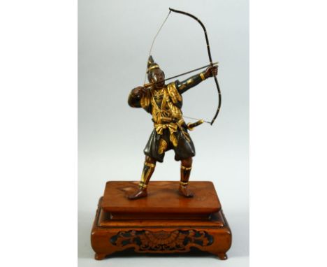 A JAPANESE GILDED BRONZE OKIMONO of a samurai archer, his bow and arrow drawn, mounted to a carved and pierced rectangular ha