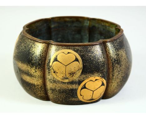 A JAPANESE GOLD LACQUERED BRONZE LOBED JARDINIERE, the exterior with applied Tokugawa Clan mon, 20cm diameter.