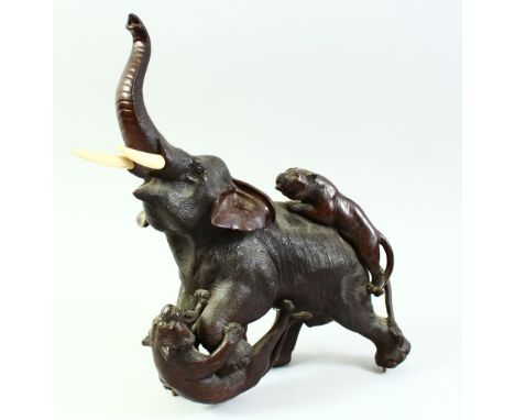 A LARGE JAPANESE MEIJI PERIOD BRONZE GROUP OF A BULL ELEPHANT being attached  by two tigers, with impressed seal mark to base