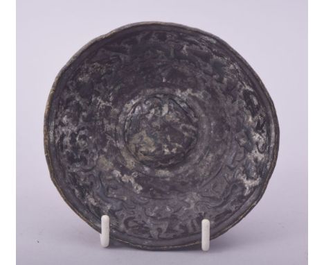 A RARE EARLY ISLAMIC OR POSSIBLY ROMAN BRONZE BOWL, the centre depicting a bird of prey surrounded by a border of various ani