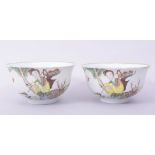 A PAIR OF 20TH CENTURY PORCELAIN BOWLS, each decorated with a female figure with a crane and a