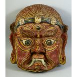 A LARGE TIBETAN CEREMONIAL PAPIER MACHE MASK, 43cm x 38cm.