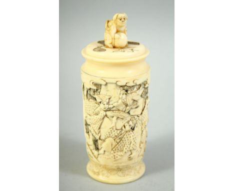 A SMALL JAPANESE CARVED IVORY CYLINDRICAL POT AND COVER, carved with various figures in an outdoor scene, the lid with carved