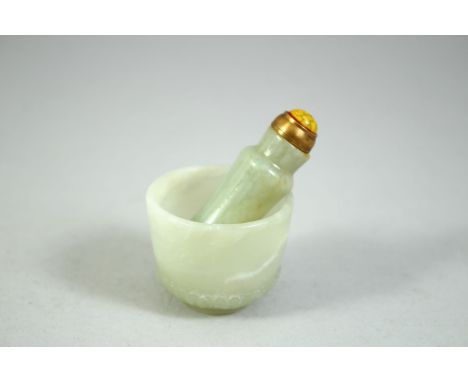 A SMALL INDIAN CARVED JADE CUP, 4cm diameter, together with a small jade snuff bottle, 5.5cm, (2).