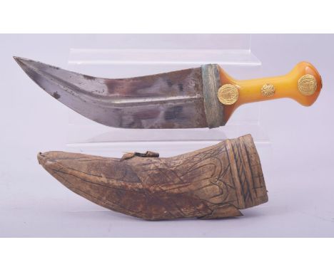 A RARE ISLAMIC ARAB JAMBIYA DAGGER, with gold mounted amber colour bakelite handle and original scabbard, 33cm overall.