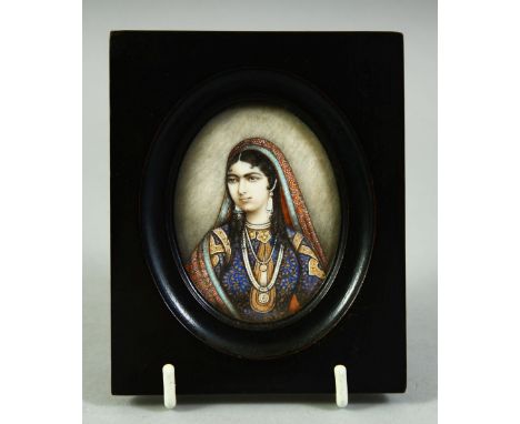 AN INDIAN MINIATURE OVAL PORTRAIT OF A FEMALE FIGURE on ivory, in an ebonised wood frame and glazed, image 7cm x 5.5cm.