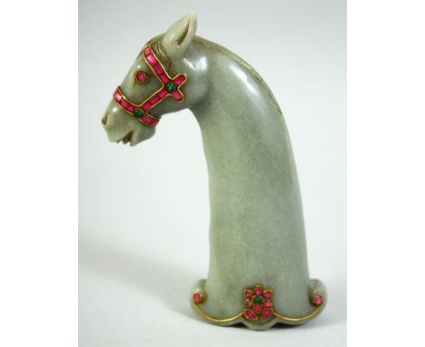 AN INDIAN GREEN HARDSTONE HORSE HEAD DAGGER HANDLE, onlaid with wirework and semi precious stones, 15cm long.