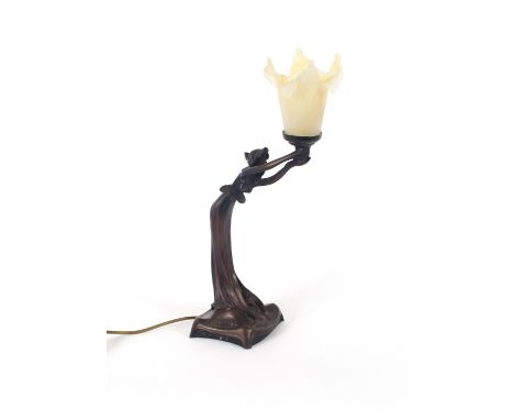 An Art Nouveau design bronzed effect table lamp, in the form of a maiden holding a flower, 46cm high overall