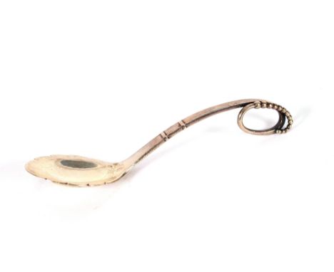 A Georg Jensen silver caddy spoon, having beaded scroll handle, initialled GJ and GJ Ltd., stamped Sterling, Denmark