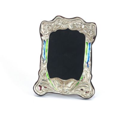 A white metal and enamel decorated easel photograph frame, decorated in the Art Nouveau style with butterflies and flowers