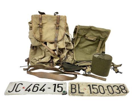 Miscellaneous militaria including WW2 French backpack, leather 'Y' straps, two Yugoslavian army vehicle number plates, US Arm