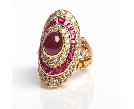 RUBY AND DIAMOND CLUSTER RING
the oval cabochon cut ruby surrounded by brilliant cut diamonds, a row of baguette cut rubies a