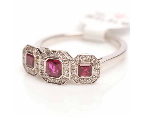 RUBY AND DIAMOND CLUSTER RING
with three emerald cut rubies surrounded by diamonds, in eighteen carat white gold, size M