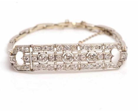 ART DECO DIAMOND BRACELET
pierced and formed by a rectangular articulated three sectioned plaque, each section set with a cen