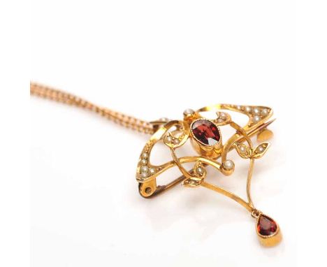 ART NOUVEAU GARNET AND SPLIT PEARL HOLBEIN
of sinuous openwork form, set with split pearls and a central oval garnet, with a 