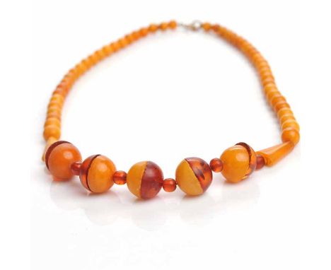 ART DECO AMBER NECKLACE
with five two tone sections made from hemispherical amber beads, and further spherical beads, 45cm lo