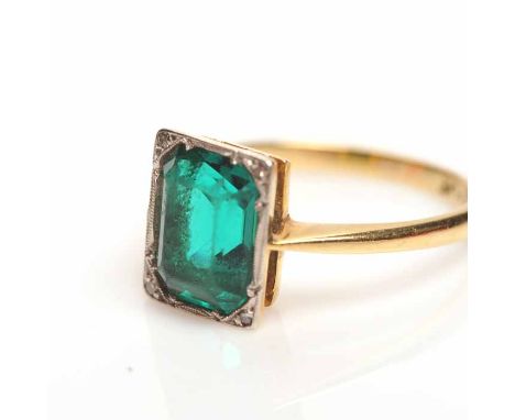 ART DECO PASTE SET RING
the emerald cut green paste in a platinum mount, on an eighteen carat gold shank, size L