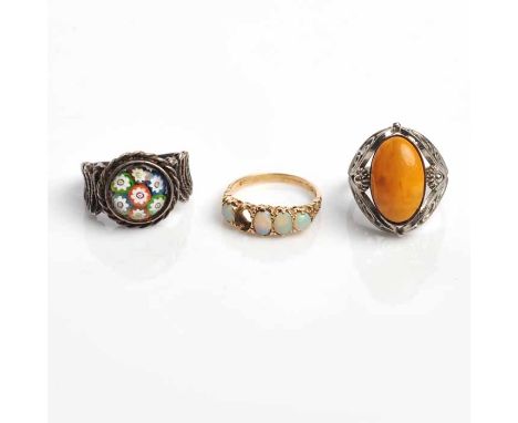 LOT OF THREE RINGS
comprising of a gold opal ring (missing stone) an amber ring in white metal, and a Caithness glass ring in