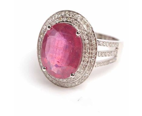 RUBY AND DIAMOND DRESS RING
the large oval ruby of approximately 6.90 carats in a diamond setting, on trifurcated diamond set