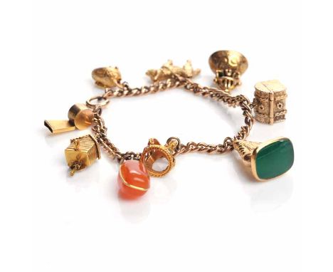 NINE CARAT GOLD CHARM BRACELET
with charms including a treasure chest, a crown and a cuckoo clock, 34.9g gross