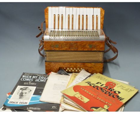 Mastertone German 12 bass piano accordion c1930's, in tangerine pearloid finish, in original carry case, with some How to Pla