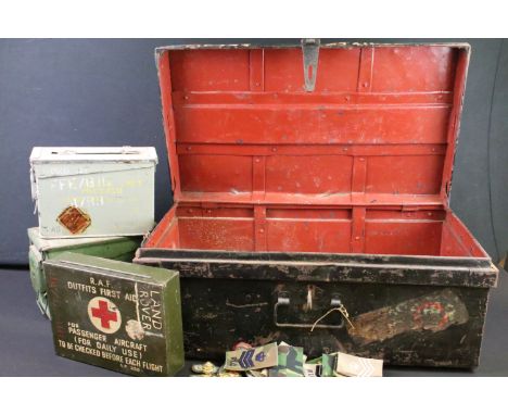 A large military metal storage trunk containing two ammunition boxes, first aid box and a small group of cloth badges. 