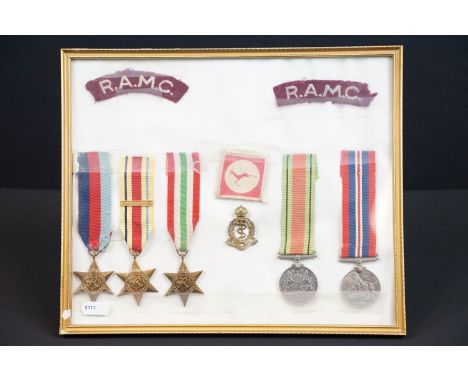 A framed and glazed World War Two medal group of five full size medals together with badges to the Royal Army Medical Corps. 