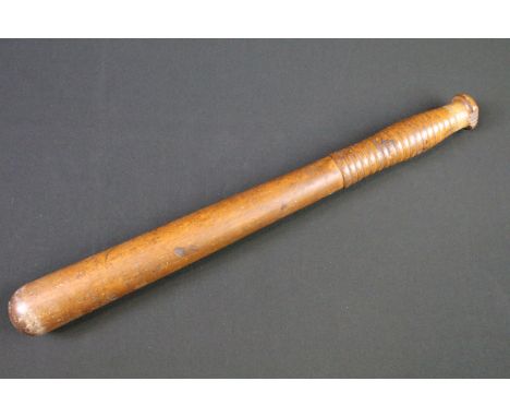 A British World war Two War Department issued wooden truncheon, marked WD together with the broad arrow mark. 
