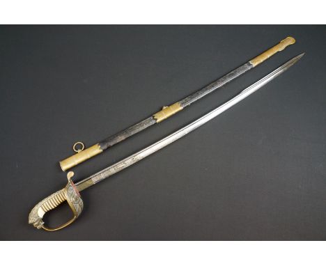 A German Imperial officers Navy dress sword complete with leather scabbard, the hilt is cast with Imperial crowned fouled anc