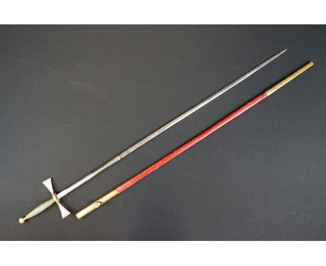 A Masonic sword with brass grip, maker marked for Spencer &amp; Co, housed within a red leather scabbard.