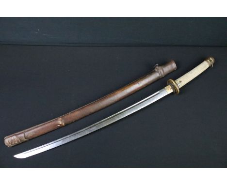 A Japanese military samurai sword, shagreen grip with bronze fittings, within fitted leather covered scabbard