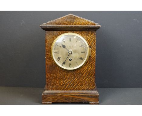 A World War Two wooden cased chiming mantle clock, the face etched with the badge of the RAF / Royal Air Force, the movement 