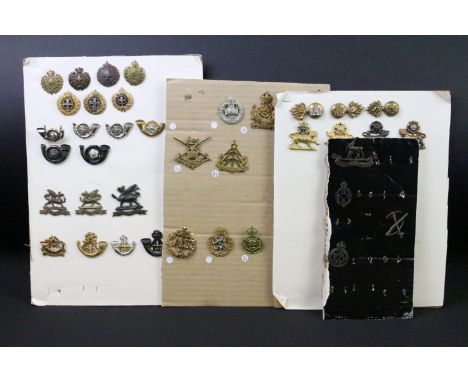 A collection of British military regimental cap and collar badges to include the  King Somerset Light Infantry, the Northampt