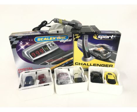 A box containing 6 Scalextric cars. As well as a Digital Lap counter. A safety car challenger. No reserve.