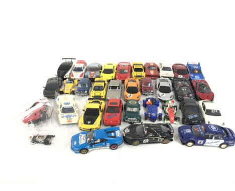 A box containing approximately 30 Scalextric cars. Plus some extra parts. No reserve.