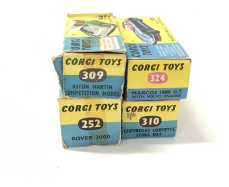 A collection of 4 boxed diecast model cars by Corgi includes No252 a Rover 2000..No309 a Aston Martin competition model..No31