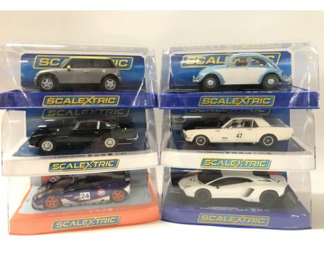 6 Boxed Scalextric Cars. A Mini Cooper. A Volkswagen Beetle. A Aston Martin DB5. A Ford Mustang. A McLaren F1 GTR And a Lambo