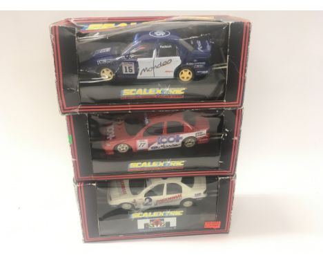 A collection of 3 boxed Scalextric cars featuring a Red a White and a Blue Ford Mondeo Cosworth. C.424. C716. C.579