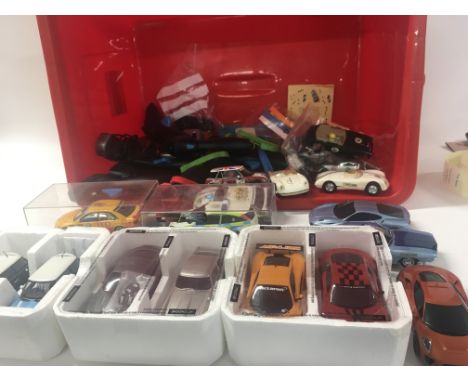 A box containing in excess of 12 Scalextric cars plus accessories and approximately 10 hand controllers.