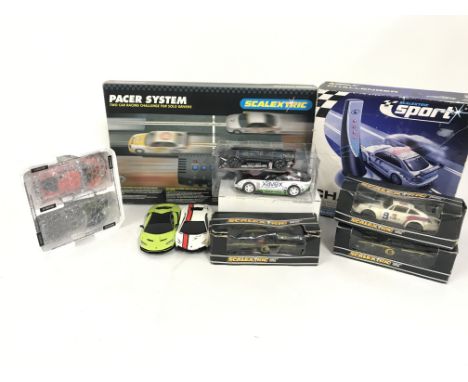 A box containing a collection of Scalextric cars as pictured. Also included is a 2 car racer system. Plus a safety car challe